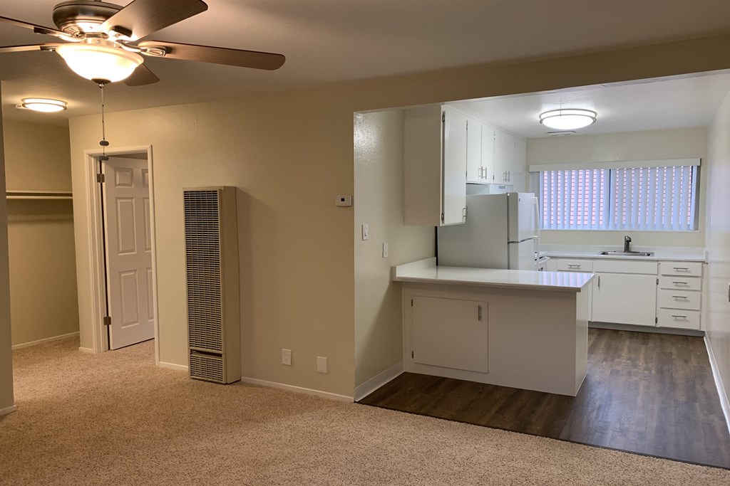 a kitchen with white cabinets and a white counter top and