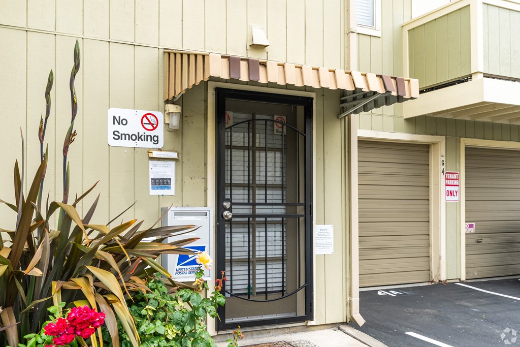 the front door of a building with a no smoking sign