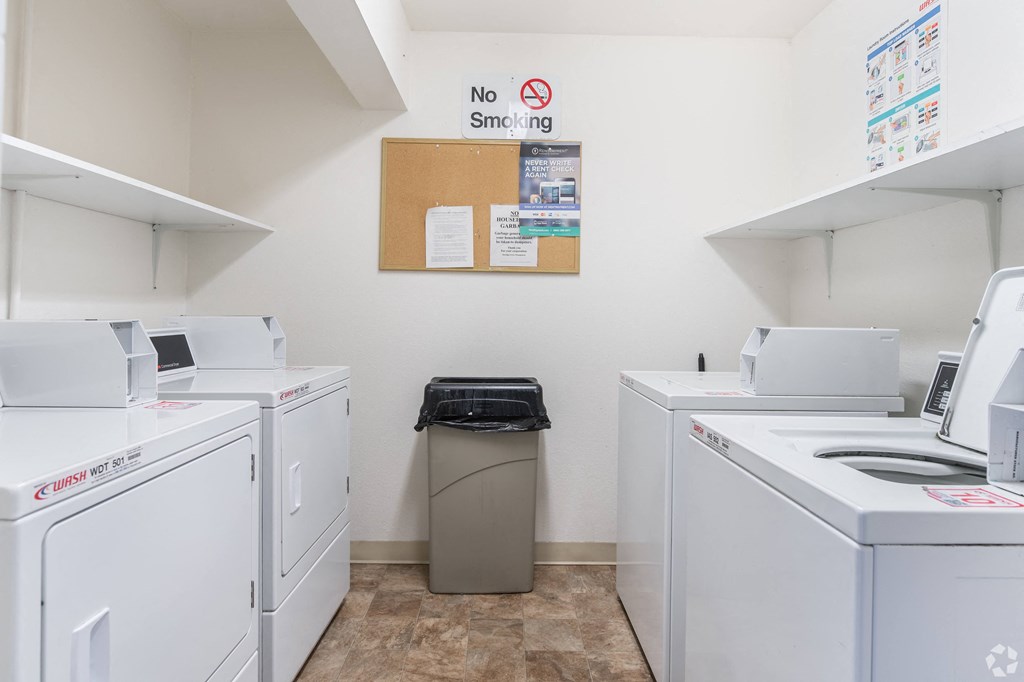 a washer and dryer in a laundry room with white appliances
