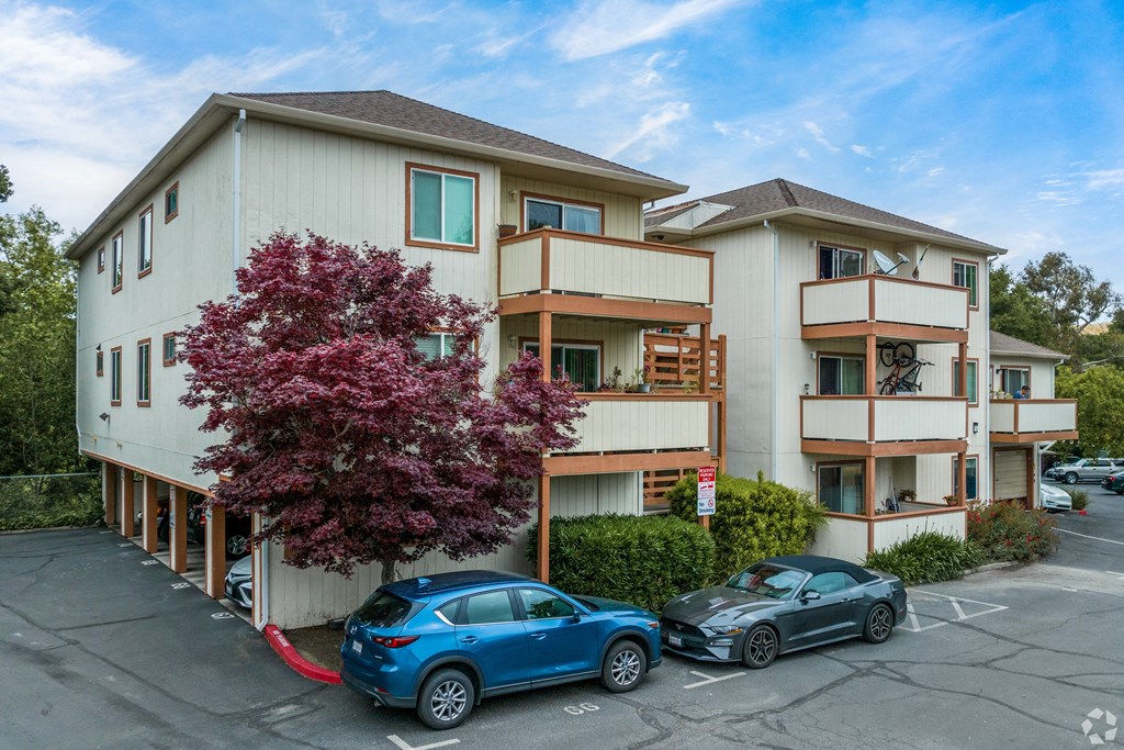 two cars parked in front of an apartment building