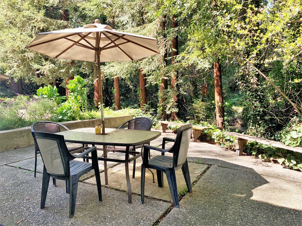 a patio with a table and chairs and an umbrella