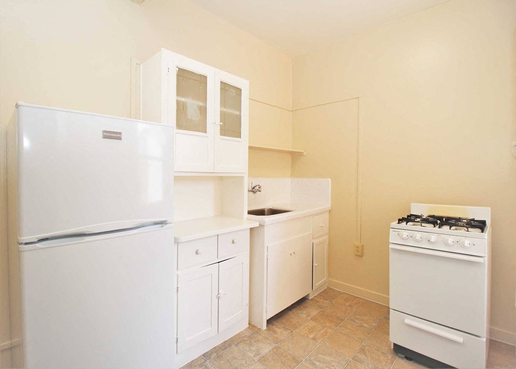 a kitchen with a refrigerator and a stove