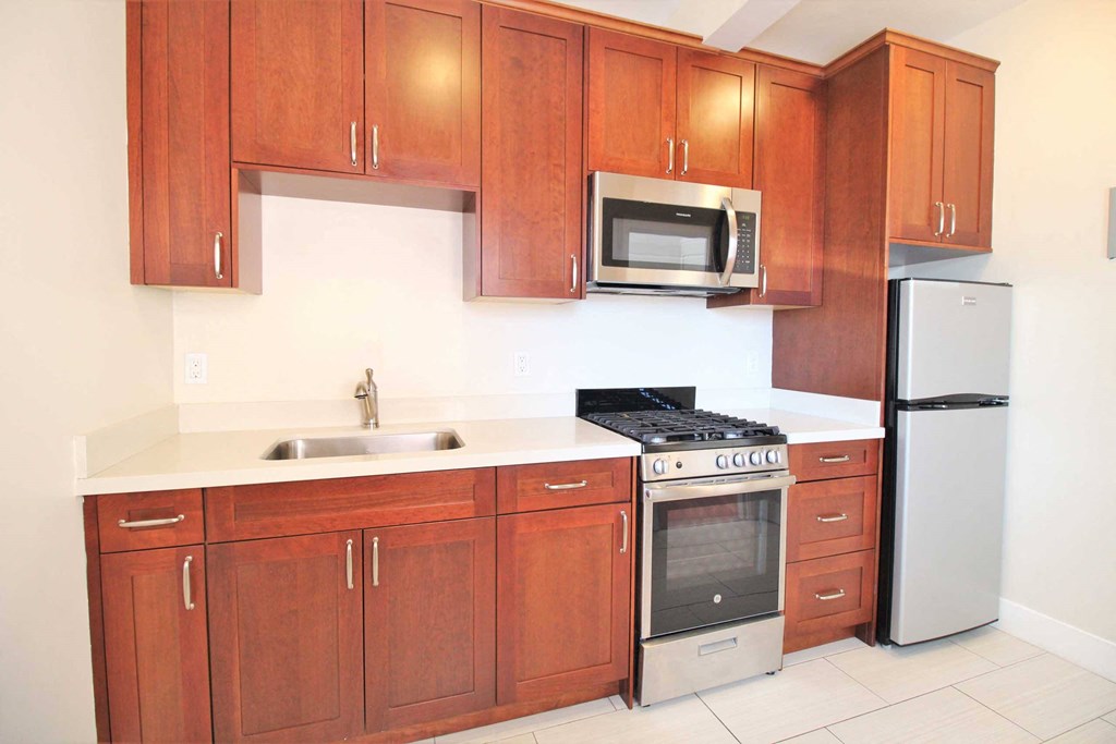 a kitchen with wooden cabinets and stainless steel appliances