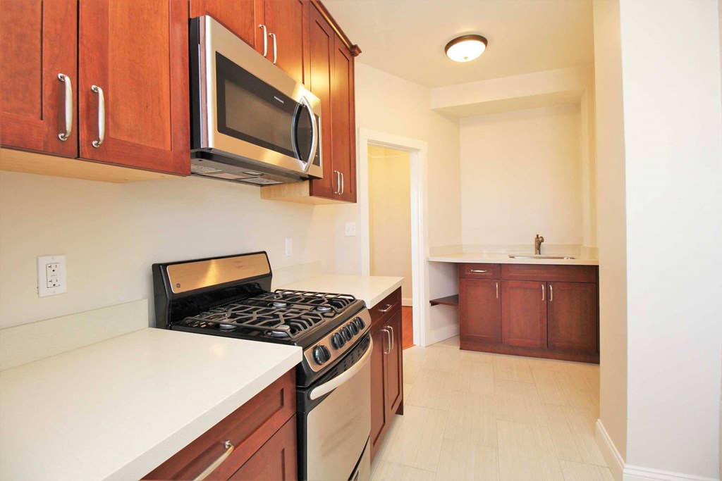 full kitchen with stainless steel appliances and a microwave