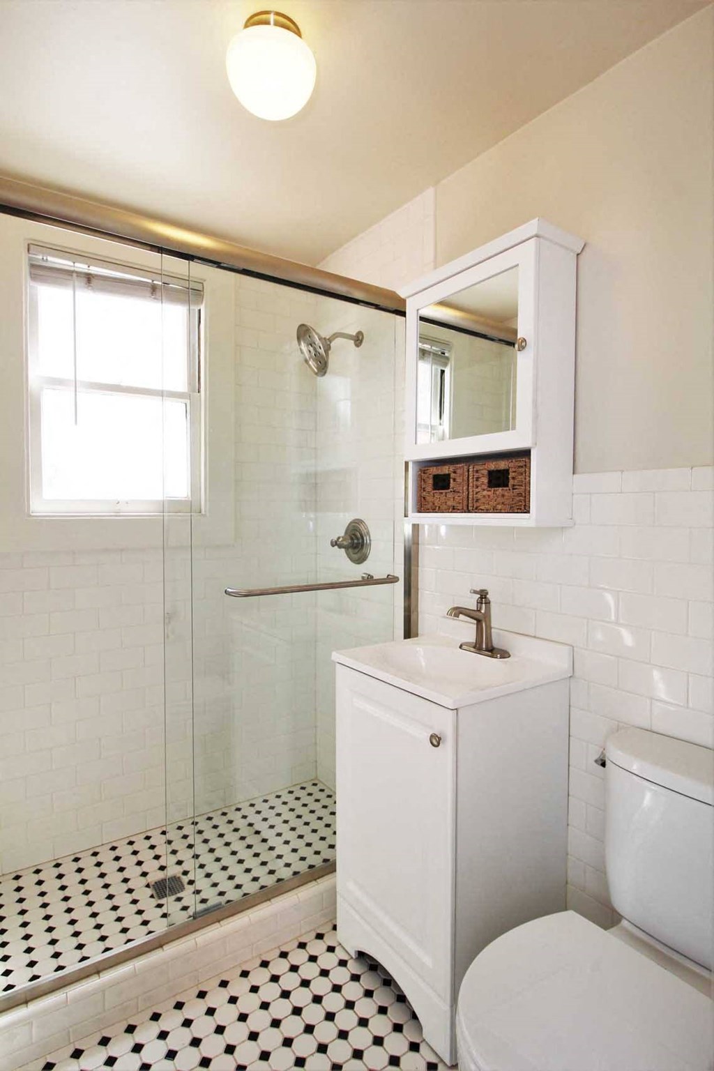 a bathroom with a toilet and a sink and a shower