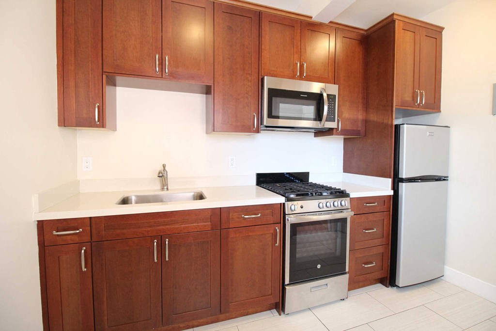 a kitchen with wooden cabinets and stainless steel appliances