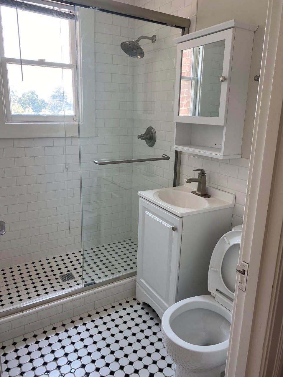 a bathroom with a toilet and a sink and a shower