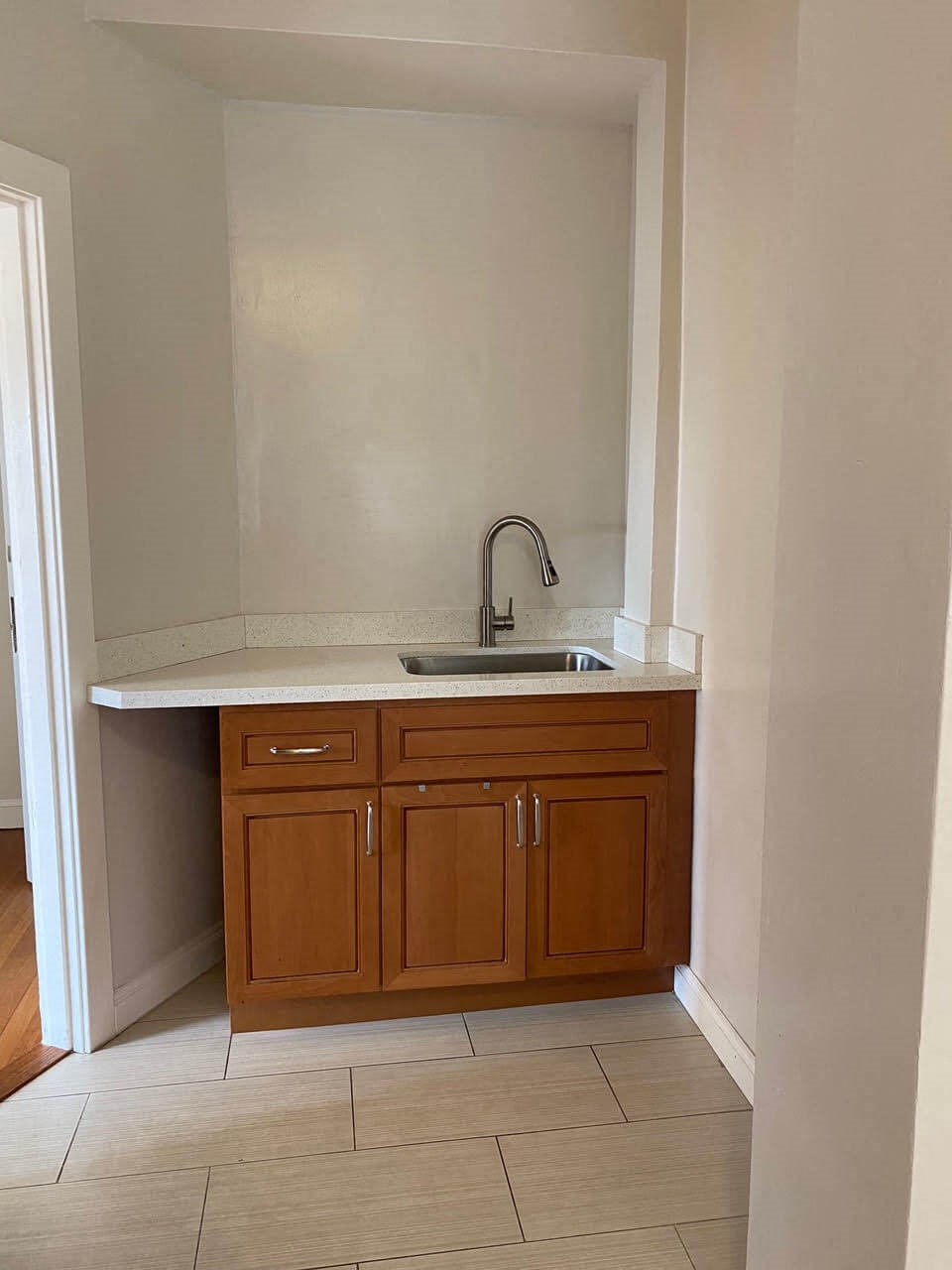 a kitchen with a sink and wooden cabinets
