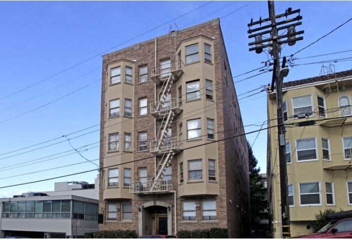 a tall apartment building with a fire escape
