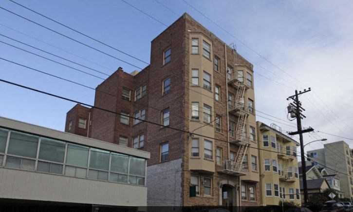 a tall brick building with a fire escape