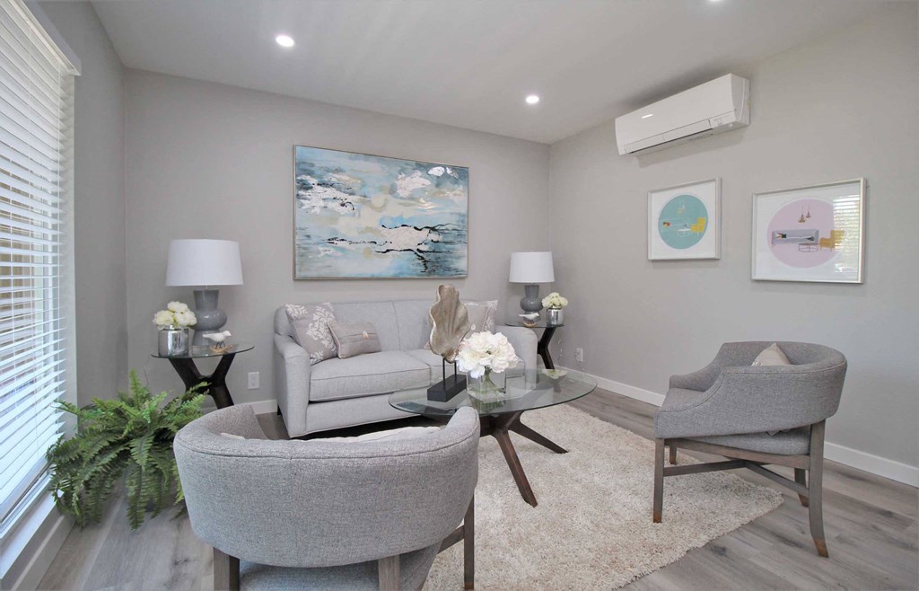 a living room with two chairs and a couch