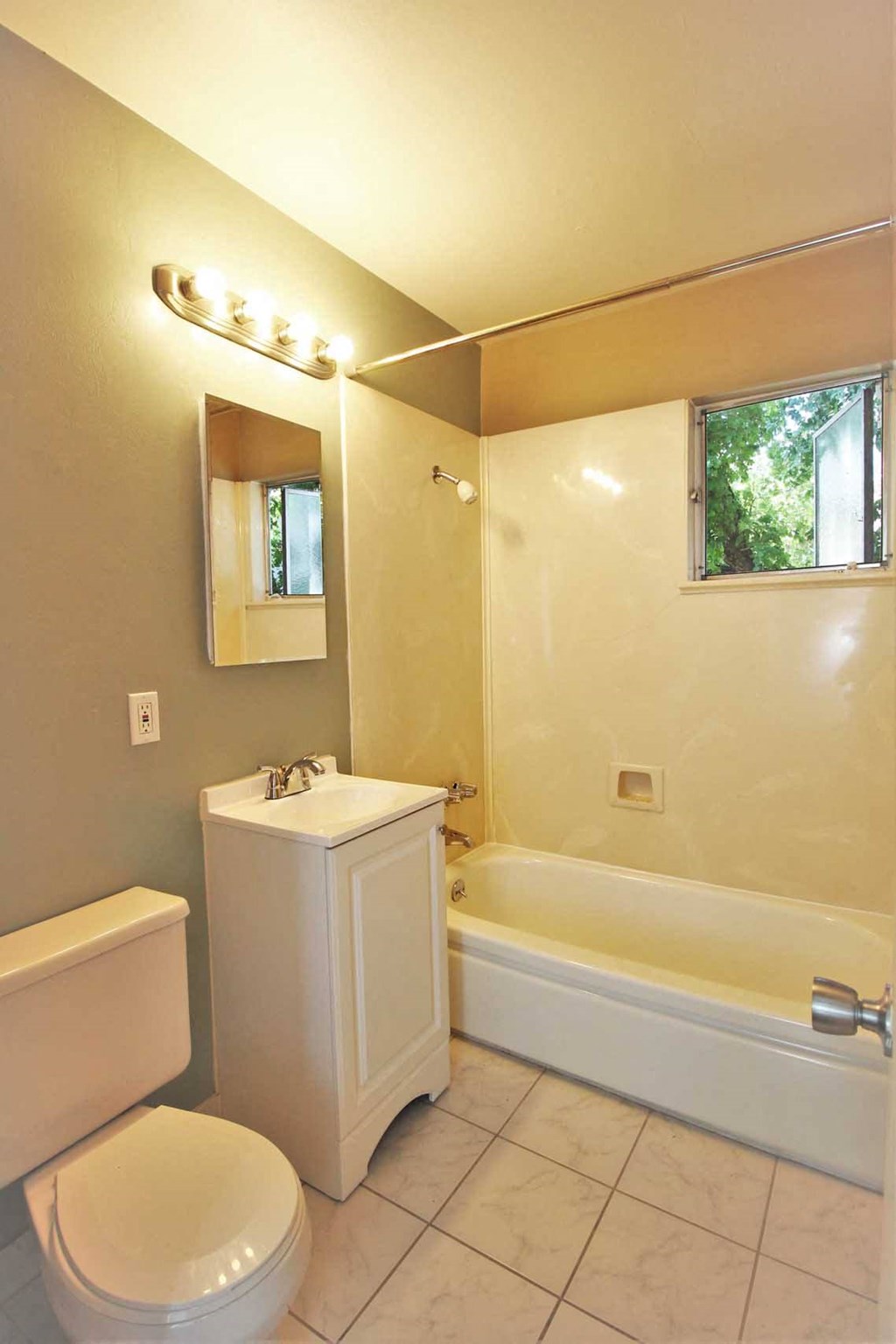 a bathroom with a toilet and a tub and a sink