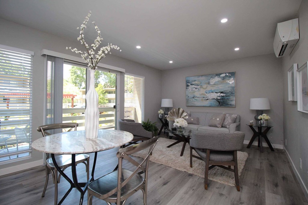 a dining room and living room with a couch and a table