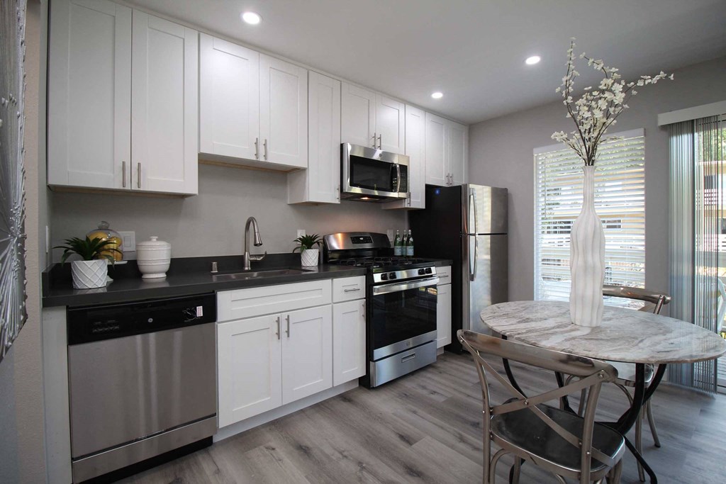 a kitchen with stainless steel appliances and a round table