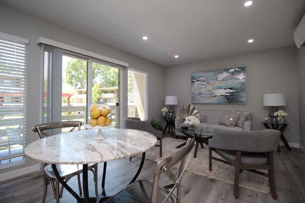 a dining room and living room with a table and chairs
