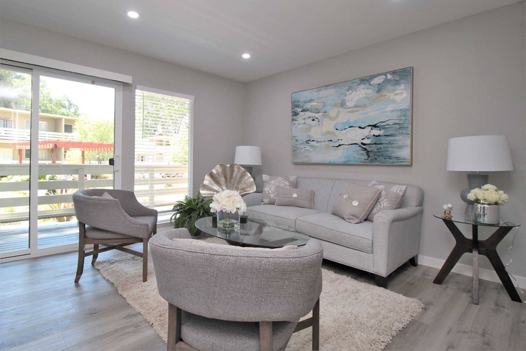 a living room with a couch and chairs