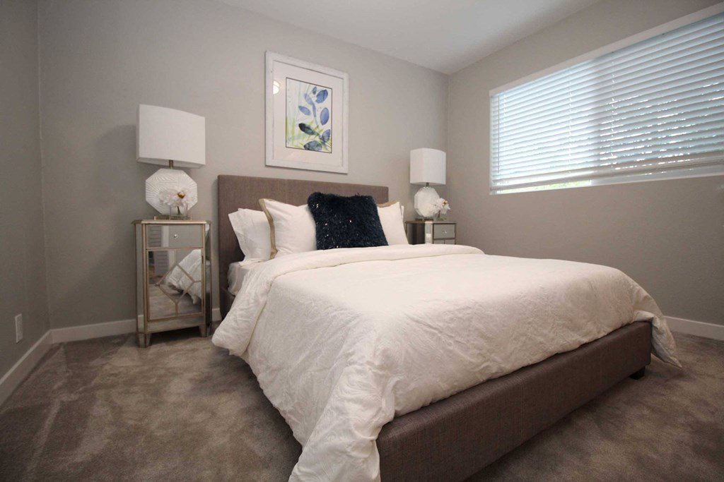 a bedroom with a large bed and a window