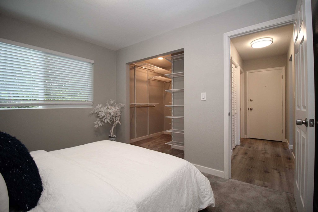 a bedroom with a large bed and a closet