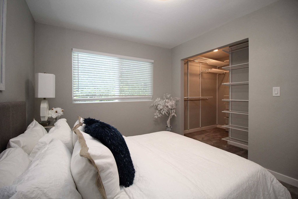 a living room with a bed and a closet