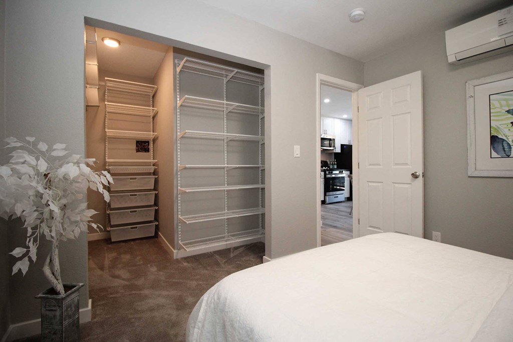 a large closet in a bedroom with a bed