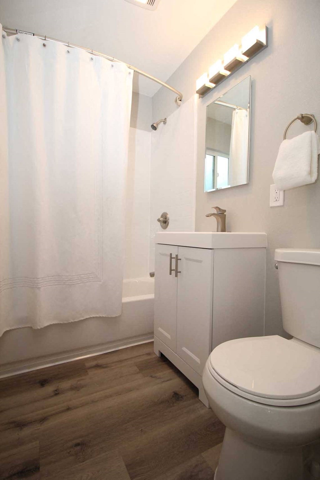 a bathroom with a white toilet and a sink