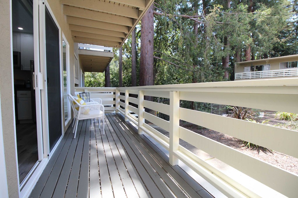 a large porch with a chair on it