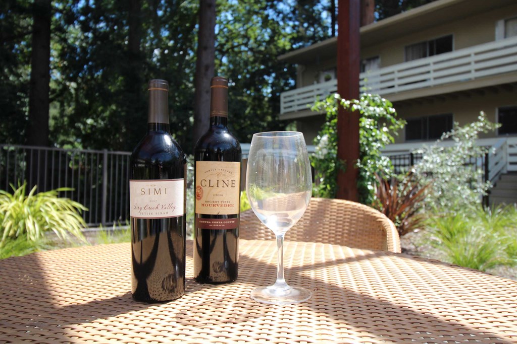 two bottles of wine and a glass on a table