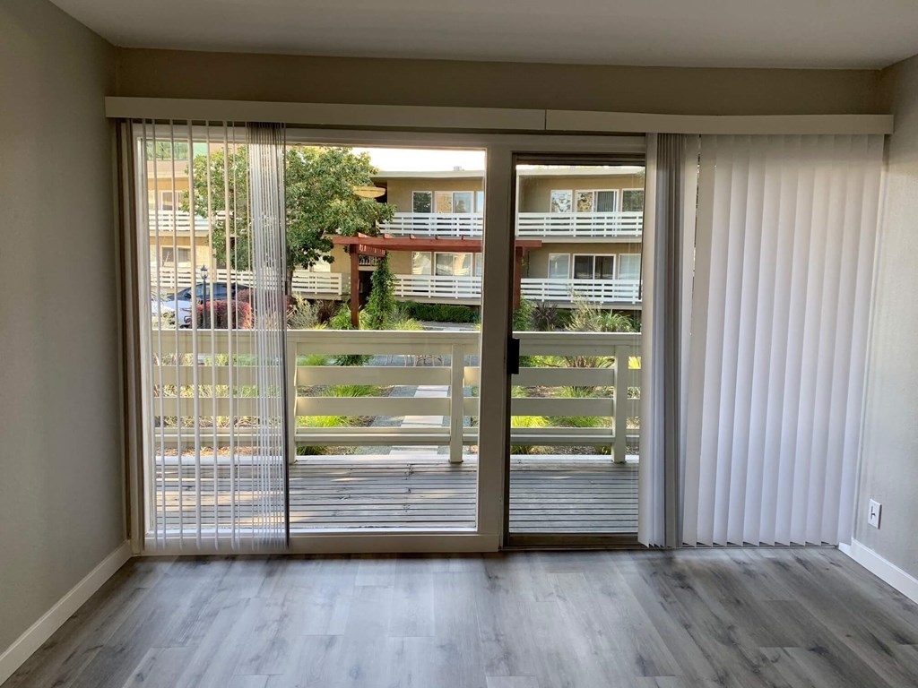 a living room with sliding glass doors and a balcony