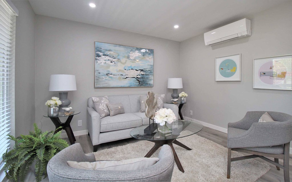 a living room with a couch and two chairs