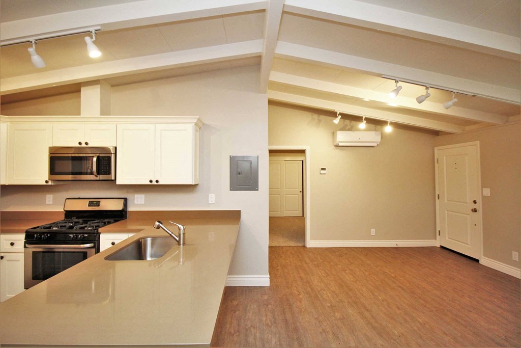 a kitchen with an island and a stove and a microwave
