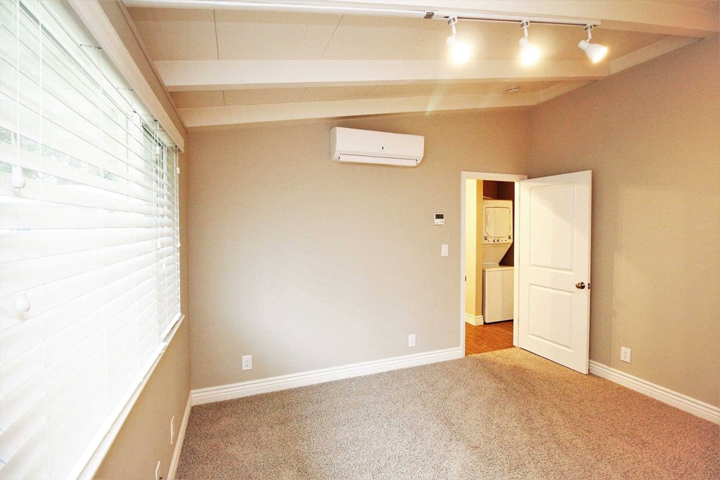 a view of an empty room with white walls and ceilings