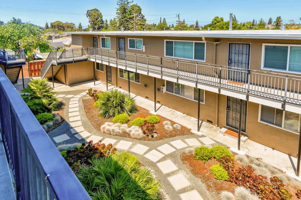 an overview of the courtyard of a building with plants and walkways