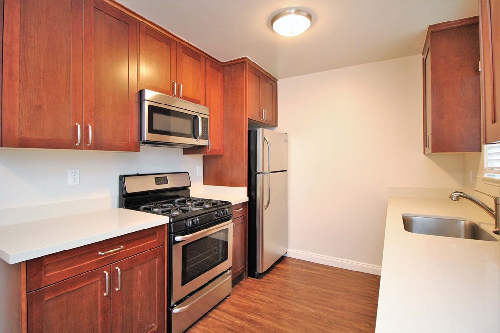 a kitchen with stainless steel appliances and wooden cabinets