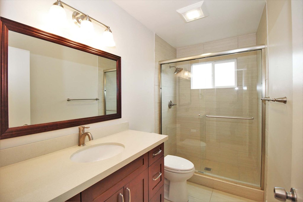 a bathroom with a sink toilet and a shower