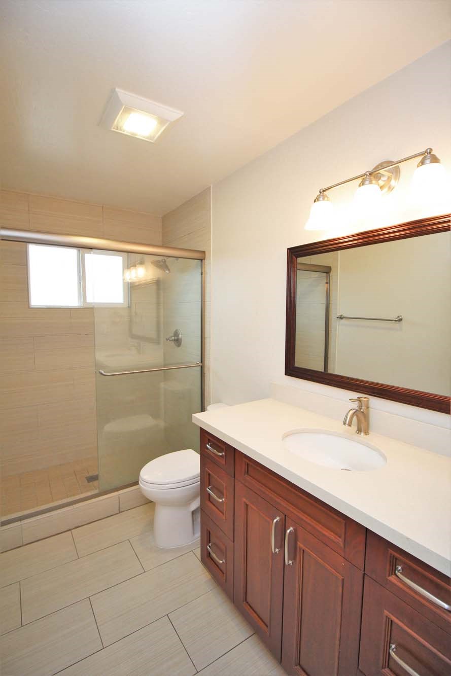 a bathroom with a sink toilet and a shower