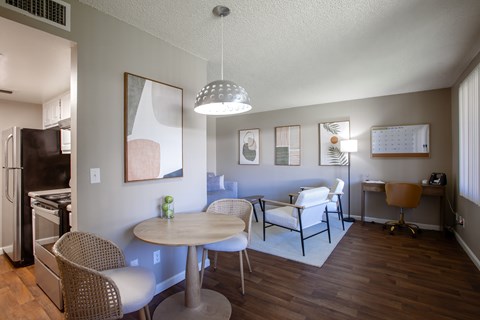A modern kitchen with a dining table and chairs.