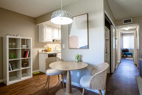 A dining room with a table and chairs.