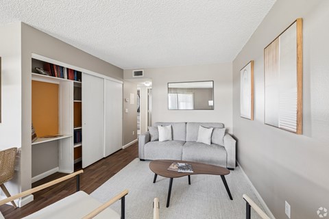 A living room with a grey couch and a coffee table.