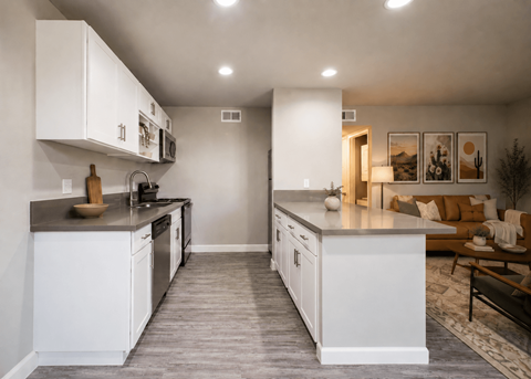 A modern kitchen with white cabinets and a large island.