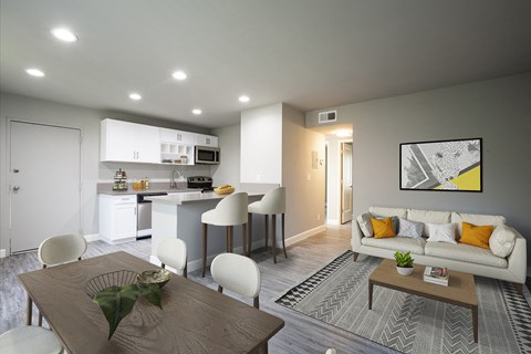 A modern living room with a dining table and chairs.