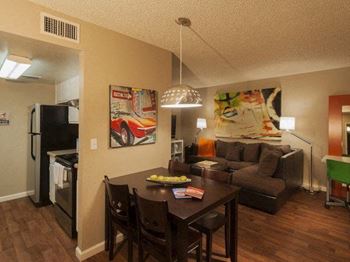 A dining room with a table set for four.