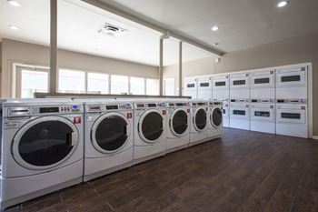 A laundromat with rows of washers and dryers.