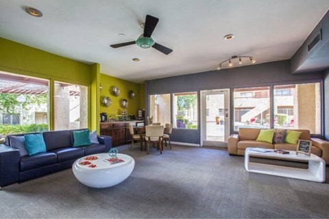 A living room with a blue couch and a white coffee table.
