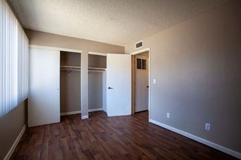 A room with a wooden floor and white walls.