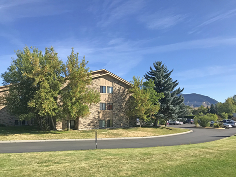 A building with a grassy area in front of it.