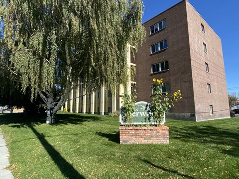 A tall building with a sign that says "The Waterway" in front of it.