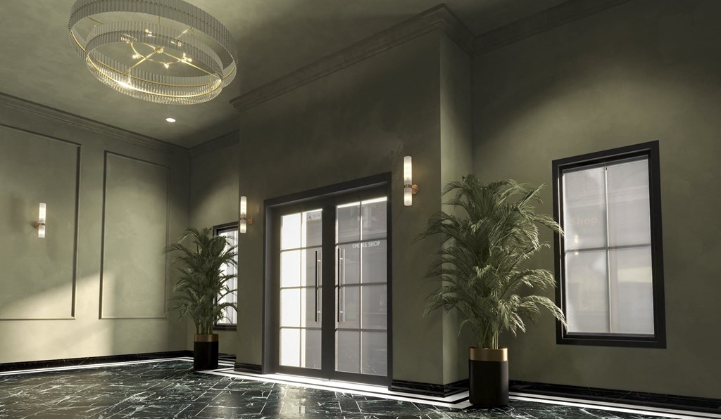 A modern hallway with a plant on either side and a chandelier hanging from the ceiling.