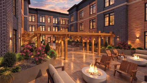 A modern building with a fire pit in the courtyard.
