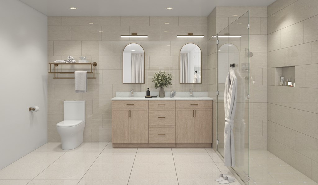 A bathroom with a toilet, sink, and mirror.