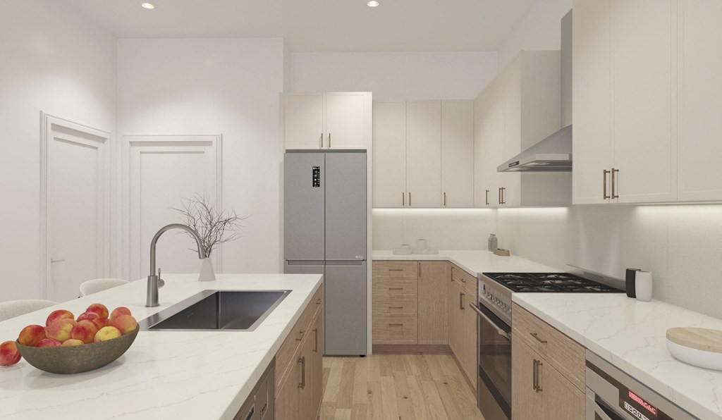A modern kitchen with a bowl of apples on the counter.